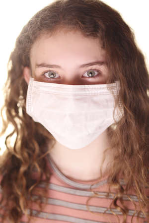 girl teenager in a mask on a white backgroundの写真素材