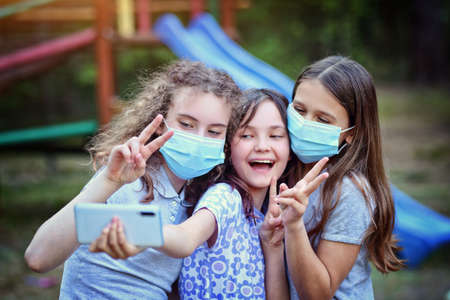 young girls have fun outside during a pandemic