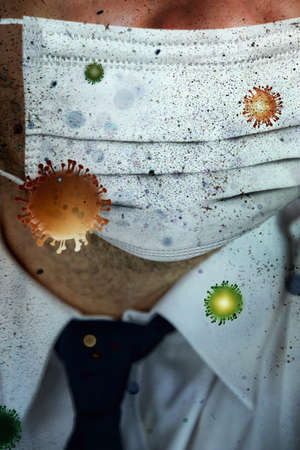 man with a mask on his face and viruses and bacteria flying aroundの写真素材