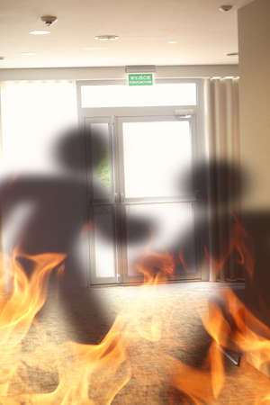Emergency exit sign with shadow escaping from fire