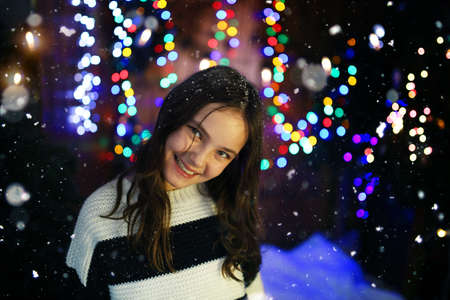 A young girl smiling in a winter eveningの写真素材