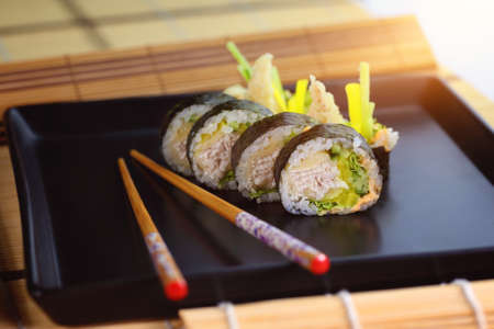 delicious dinner - healthy and tasty sushi with rice appetizingly served