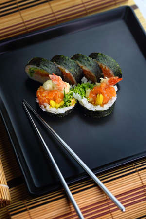 fish sushi on a ceramic plate in a traditional asian recipeの写真素材