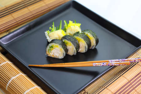 fish sushi on a ceramic plate in a traditional asian recipeの写真素材