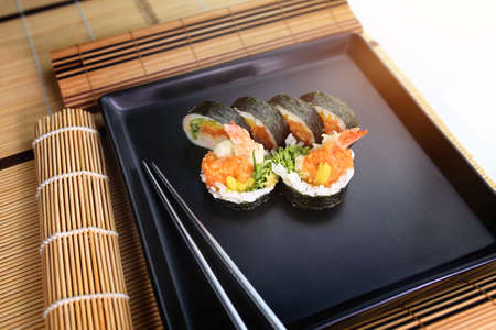 fish sushi on a ceramic plate in a traditional asian recipeの写真素材