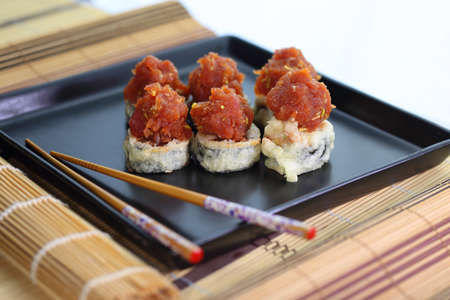appetizing fish tartare sushi served nicely on a black plateの写真素材