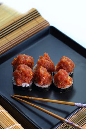 appetizing fish tartare sushi served nicely on a black plateの写真素材