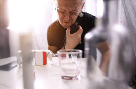 tired and drunk guy addicted to alcoholの写真素材