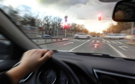 Driving a car on red sign lightの写真素材