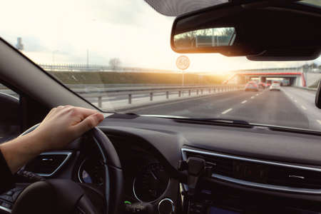 Driving a car in the city on a sunny dayの写真素材