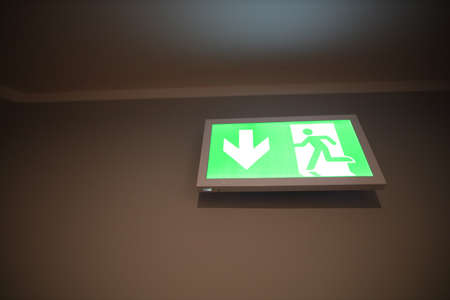 Emergency exit sign on the office wallの写真素材