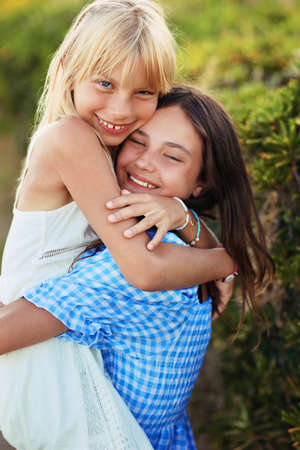 two friends and young laugh on a sunny dayの写真素材