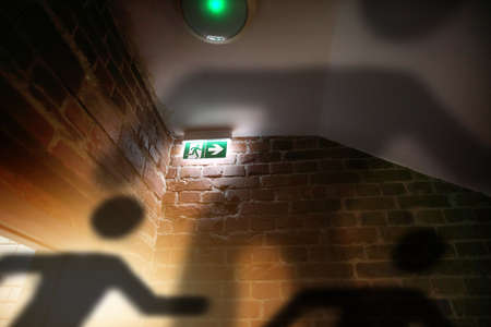 escaping figurines during a fire on emergency exitの写真素材