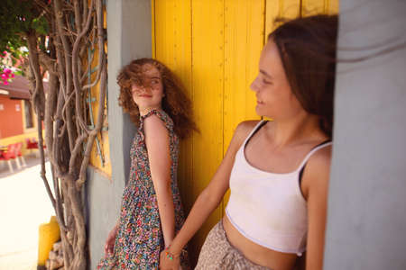 two young friends are walking and laughingの写真素材