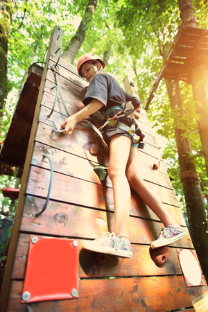 teenager climbs in the rope parkの写真素材