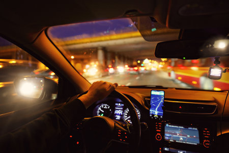 Driving a car at night in the cityの写真素材