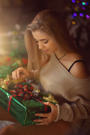 young girl wraps gifts for Christmasの写真素材