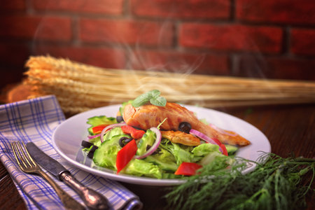 Delicious grilled salmon served with saladの写真素材