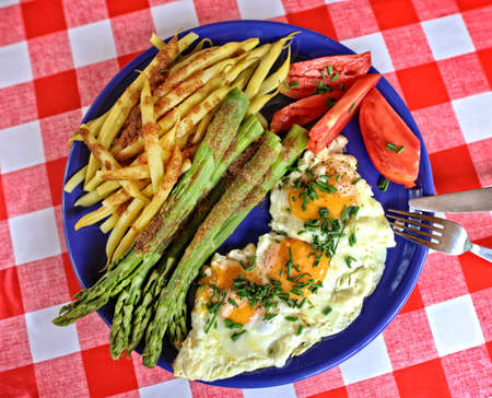 Delicious homemade dinner - egg with beans and asparagus and tomatoの写真素材