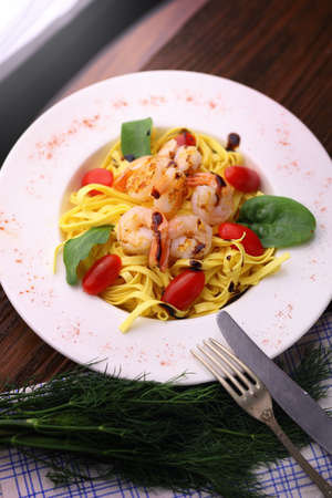 delicious and healthy prawns served with pasta and cherry tomatoesの写真素材
