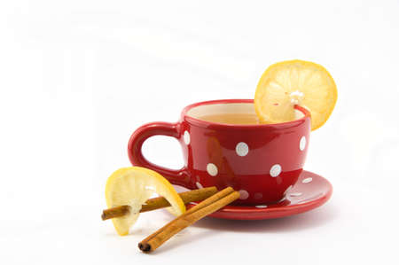 Cup of tea with lemon and cinnamon on isolated white backgroundの写真素材