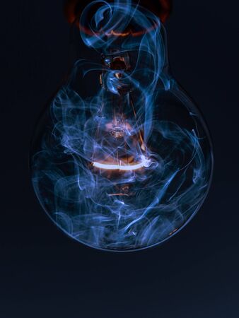 Glowing bulb with smokeの写真素材
