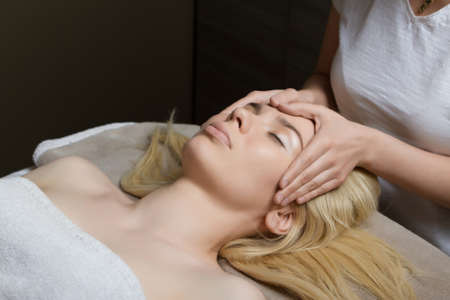 Young woman receiving massage at spa salonの写真素材
