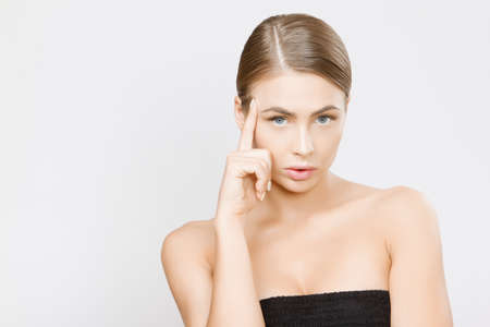 Beautiful young woman face close up studio on greyの写真素材