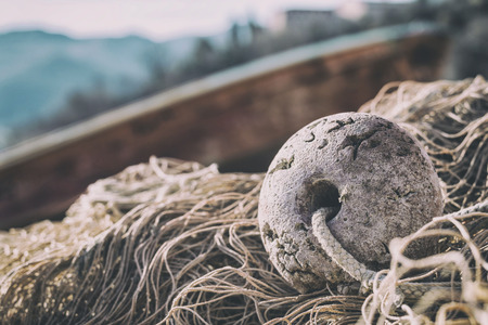 Fishnet and boat on the beach with beautiful background landscape, Italyの写真素材