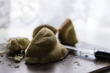 Knife and bread on wooden cuttin board with bread crumbsの写真素材