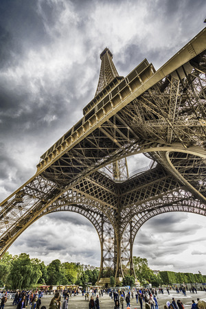 PARIS, FRANCE - APRIL 2017: Beautiful Eiffel Tower  vertical photo with people under the towerのeditorial素材