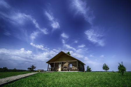 Beautiful landscape o cottage in the green anduer blue skyの写真素材