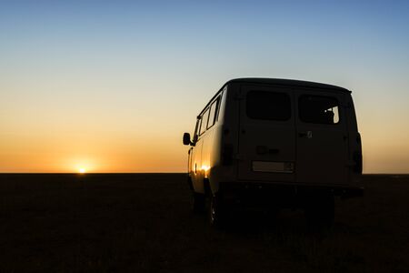 Vintage retro car in the red sunset of desertの写真素材