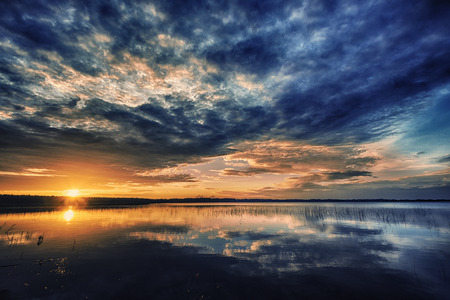 Beautiful red sunset landscape on lakeの写真素材