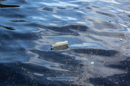 Ecological problem, plastic water bottle floating on water surface.の写真素材