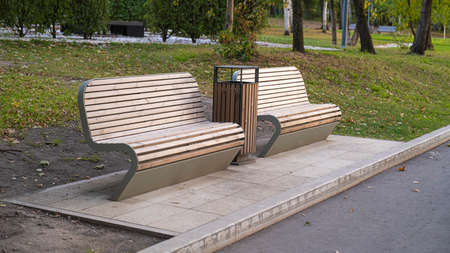 VDNH. The empty benches. Beautiful Sunny city landscape with two benches on the sidewalk. Park benches on the pedestrian path.の写真素材
