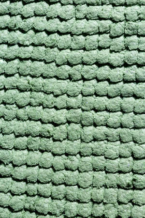 Microfiber texture with a soft large pile. Top view texture of light green big microfiber fabric towel. Beautiful microfiber cloth, green microfiber.の写真素材