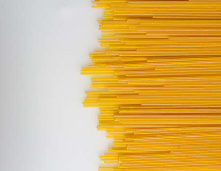 Italian pasta design template with copy space, a flat lay of many pasta, shot from above on a white backgroundの写真素材