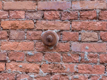 Restoration of historical buildings. Repair of a stone wall.Close-up of an iron support on a brick wall.の写真素材
