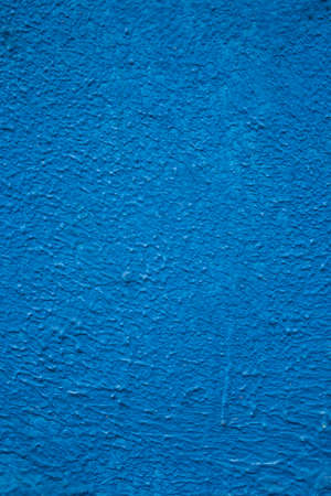 Roughly painted wall with dark blue paint. Evidence of blue paint. Beautiful Abstract Grunge Decorative Navy Blue Dark Wall Background. Art Rough Stylized Texture Banner With Space For Textの写真素材