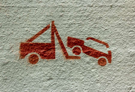 Evacuation road sign painted on the wall. Traffic signs stop is prohibited and the evacuation of cars. Evacuation of the car. No parking zone. Road safety. Road accidentの写真素材