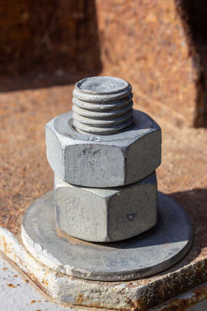 Large head bolt on metal construction as background - engineering concept. Metal head of bolt...