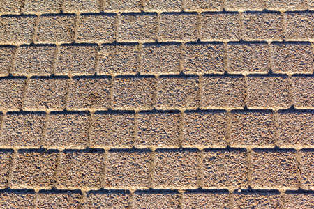 Rusty sewer manhole cover. Geometric pattern on the cover of the sewer manhole. Rusty sewer manhole cover. Close-up view of the texture of the old rusty metal sewer manhole. Copy space and backdropの写真素材