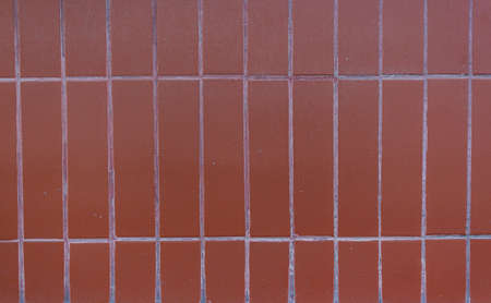 Background of brown ceramic tiles. Full frame image of brown ceramic tile wall backgroundの写真素材