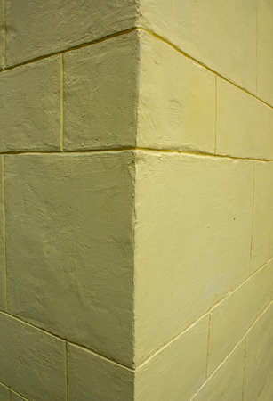 Fragment of the corner of the walls of the old yellow house.の写真素材