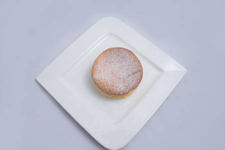 A low contrast Hero Shot of a pan cake on a plate, on a minimal white background with a diagonal 60 degree angleの写真素材