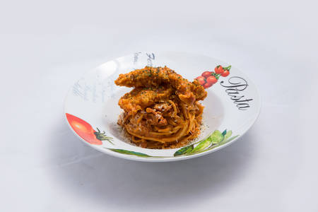 A low contrast Hero shot of chicken curry with pasta noodles in a plate with minimal white background with 60 degree angle from front perspectiveの写真素材