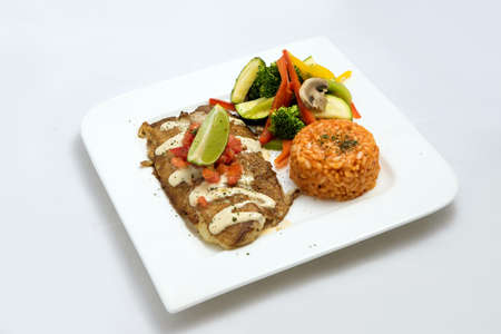 A Hero shot of a grilled fish fillet gratini with vegetables & lentils on the side, on a white plate, minimal background with a 60 degree front facing perspective.の写真素材