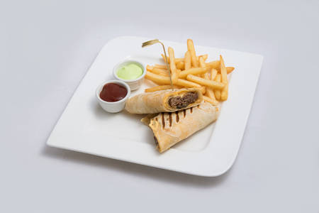 A low contrast Hero shot of a beef wrap sandwich with samurai & alger sauce and fries on the side, on a minimal white background with a 45 degree angle from front zoomed in perspectiveの写真素材