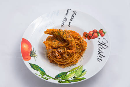 A low contrast Hero shot of chicken curry with pasta noodles in a plate with minimal white background with 60 degree angle from front perspectiveの写真素材